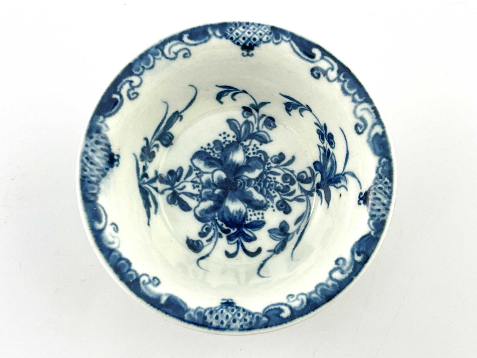 A Worcester blue and white patty pan, cr: A Worcester blue and white patty pan, crescent mark, circa 1770, decorated in the Mansfield pattern, 10.5cm diameter