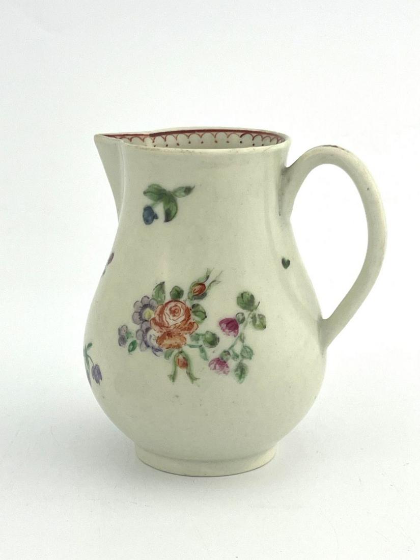 An English porcelain sparrow beak cream: An English porcelain sparrow beak cream jug, circ 1765, painted with polychrome floral sprays, 10cm high