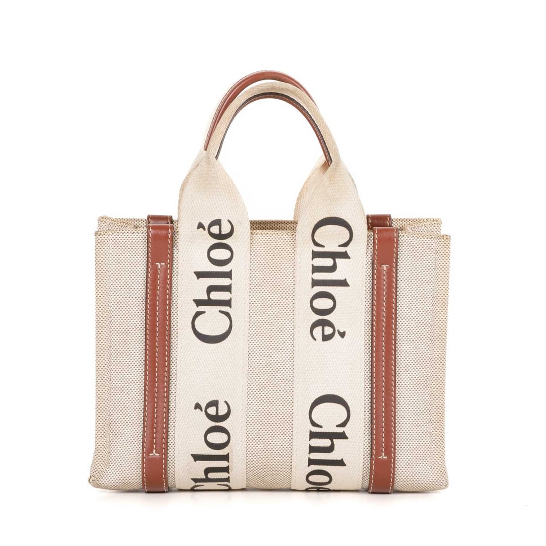 Chloe, a small Woody tote, designed with: Chloe, a small Woody tote, designed with a beige canvas exterior and brown leather trim, featuring logo branded wraparound canvas detailing, dual top handles, detachable leather crossbody strap, an op