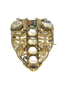 John Paul Cooper, an Arts and Crafts yel: John Paul Cooper, an Arts and Crafts yellow metal, gem set and enamelled brooch, circa 1900, reticulated shield form with ropetwist border, filigree type scroll and beaded foliate fronds, the central