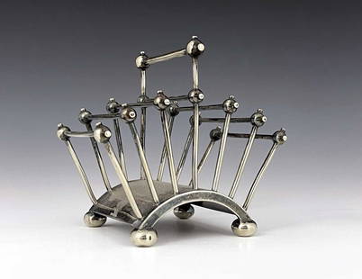 Christopher Dresser for Hukin and Heath,: Christopher Dresser for Hukin and Heath, a silver plated six division toast rack, circa 1881, model 2556, the barrel arched base with four pad feet, the rod dividers united by spherical balls,