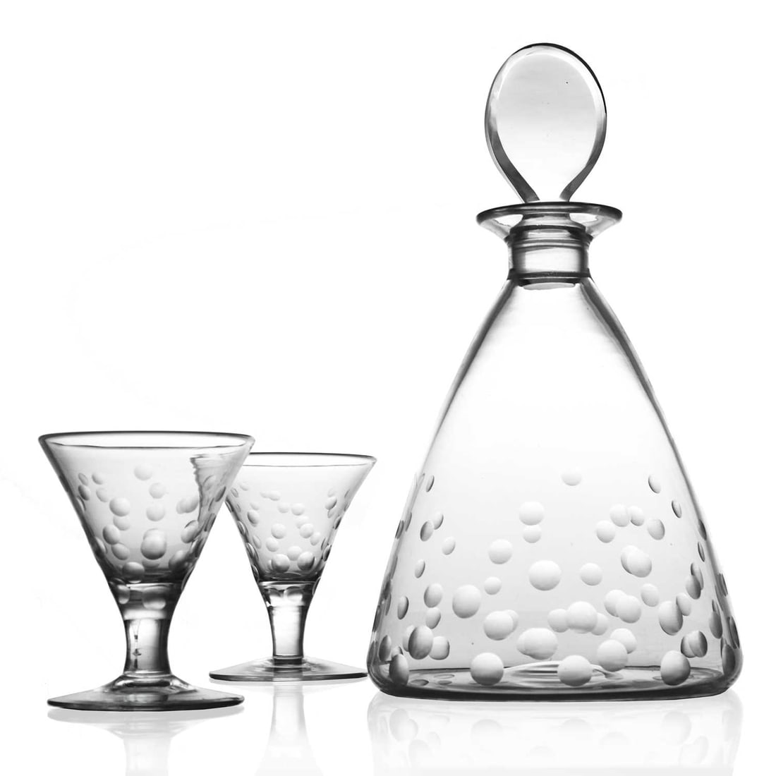 Keith Murray for Stevens and Williams, R: Keith Murray for Stevens and Williams, Royal Brierley, an Art Deco cut glass decanter and glasses, domed conical form with graduated random frosted lens cuts, flat lozenge stopper, 23.5cm high (3)