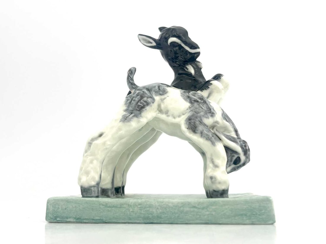 Doris Lindner for Royal Worcester, Kids: Doris Lindner for Royal Worcester, Kids at Play, circa 1937 modelled as two prancing goats on celadon glazed rectangular base, green printed mark, 12cm high