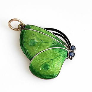 Child and Child, an Arts and Crafts silv: Child and Child, an Arts and Crafts silver gilt and enamelled butterfly pendant, basse taille green enamel wings, set with sapphire eyes, stamped daisy mark, 3.5cm long