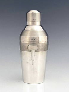 An Art Deco silver cocktail shaker, Elki: An Art Deco silver cocktail shaker, Elkington and Co., Birmingham 1936, conical form with stepped shoulder, barleycorn engine turned bands and incised block cartouche, 21cm high, 12.78ozt