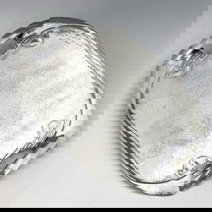Archibald Knox for Liberty and Co., a Tu: Archibald Knox for Liberty and Co., a Tudric Arts and Crafts pewter tray, model 0231, planished and cast with knotted tendrils, 48cm long