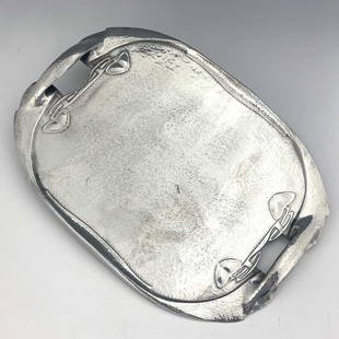 Archibald Knox for Liberty and Co., a Tu: Archibald Knox for Liberty and Co., a Tudric Arts and Crafts pewter tray, model 0231, planished and cast with knotted tendrils, 48cm long