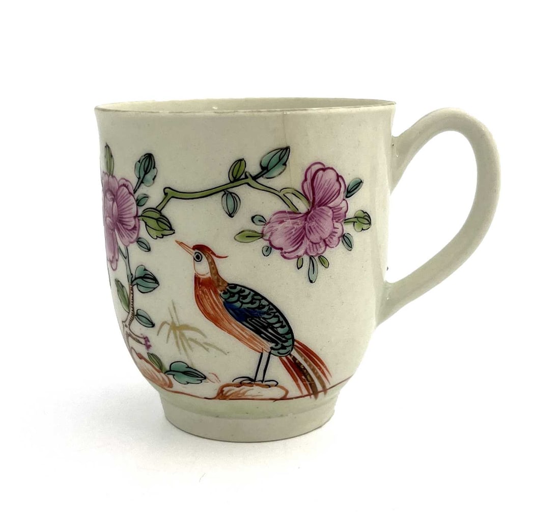 A Worcester polychrome coffee cup, circa: A Worcester polychrome coffee cup, circa 1768, painted with bird on a rock and peony design, 6.5cm high