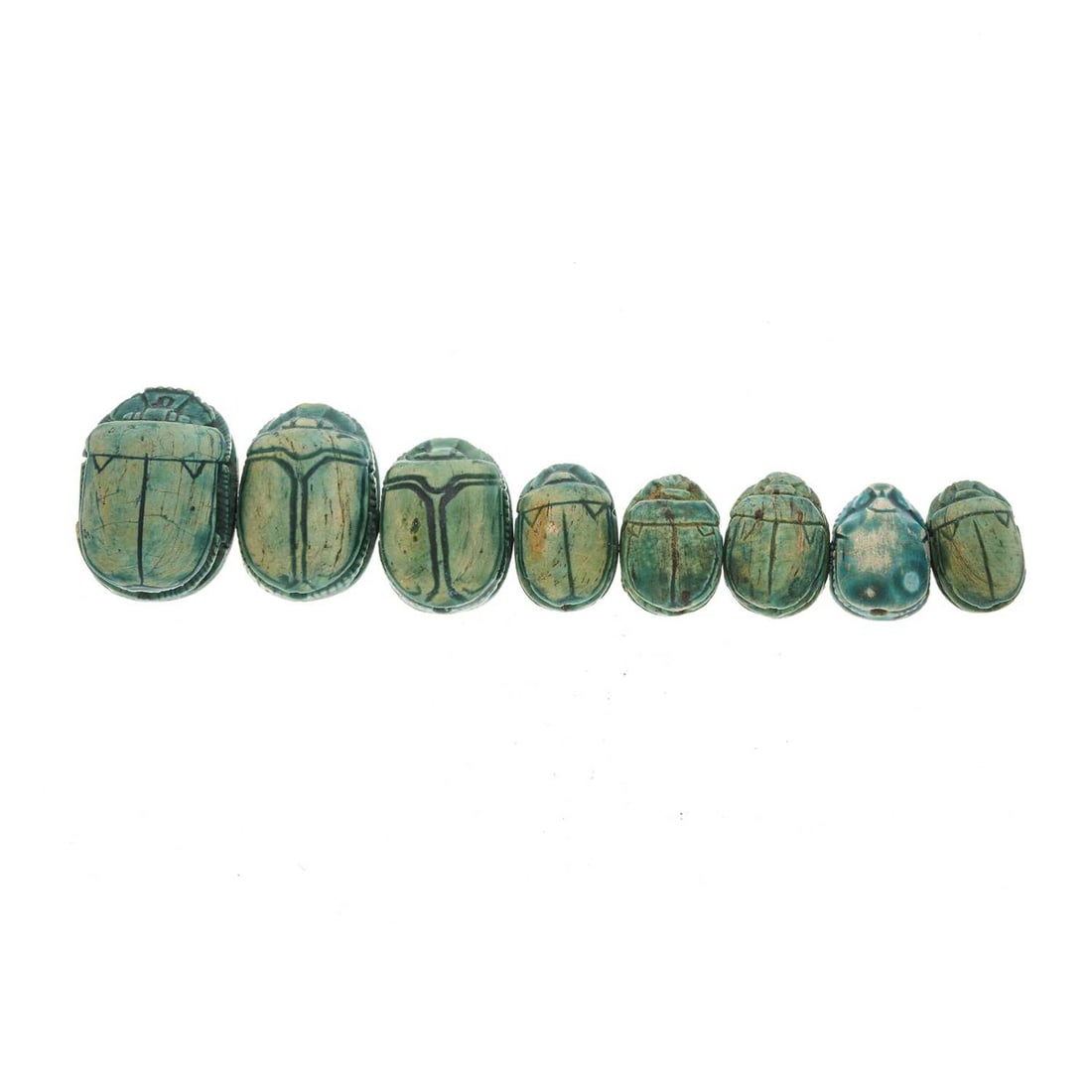 A selection of eight Egyptian Revival fa: A selection of eight Egyptian Revival faience scarab beetles, lengths 1.4 to 2.2cm, total weight 20.9g