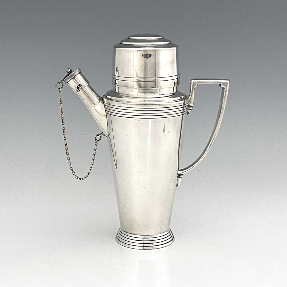 Keith Murray for Mappin and Webb, an Art: Keith Murray for Mappin and Webb, an Art Deco silver plated cocktail shaker, circa 1933, shouldered conical form with bands of concentric rings, angled and stepped handle, the pouring spout with bayon