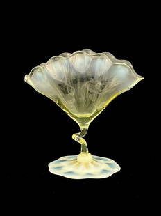 John Walsh Walsh, an Arts and Crafts str: John Walsh Walsh, an Arts and Crafts straw opal glass vase, circa 1900, the optic ribbed fan shaped body with crimped rim, on a coiled tendril stem and octagonal petal foot, 19cm high