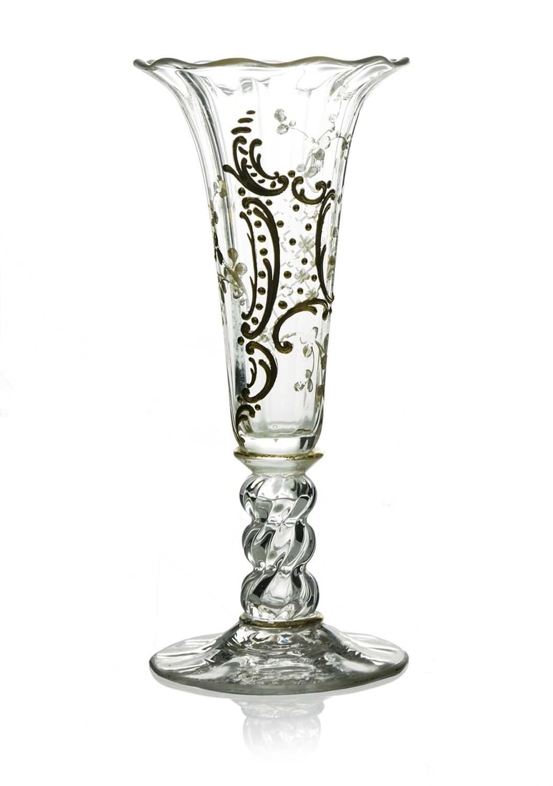 Jules Barbe for Thomas Webb, an Arts and: Jules Barbe for Thomas Webb, an Arts and Crafts glass vase, the optic ribbed trumpet form bowl decorated with raised gilt Rococo scroll cartouche and foliate sprigs, on a hollow triple knopped stem an