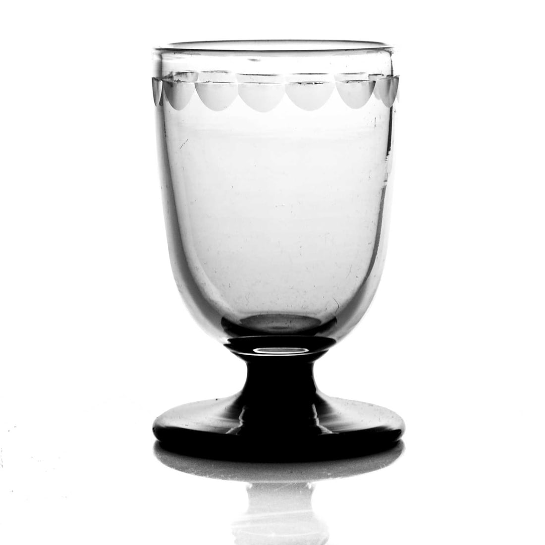 Keith Murray for Stevens and Williams, a: Keith Murray for Stevens and Williams, an Art Deco Royal Brierley sherry glass, model 429A, circa 1934, the beaker form bowl with frosted half lens cut border, on a black foot, 7.5cm high