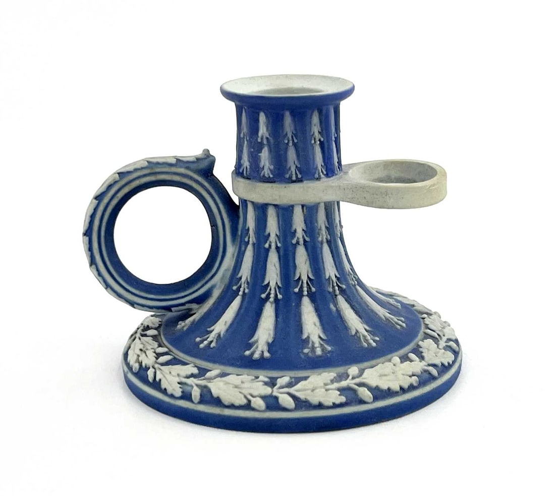A Wedgwood blue Jasperware chamber stick: A Wedgwood blue Jasperware chamber stick, circa 1790, fluted trumpet form, with husk garlands and oak leaf wreath, impressed mark Wedgwood, 6cm high