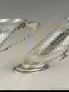 Hester Bateman. A George III silver mug,: Hester Bateman. A George III silver mug, of baluster form, atop a spreading stepped circular form foot, the double S scroll handle with acanthus leaf thumbpiece, the body initialled, 'JSH' or similar,