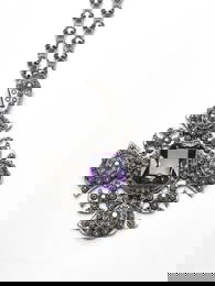 A late Victorian gem-set pendant, with chain, in the form of a cross with filigree studs and central