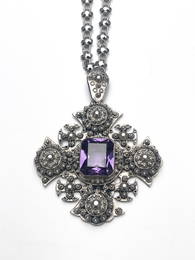 A late Victorian gem-set pendant, with chain, in the form of a cross with filigree studs and central