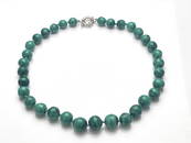 A malachite bead necklace, with silver spring ring clasp