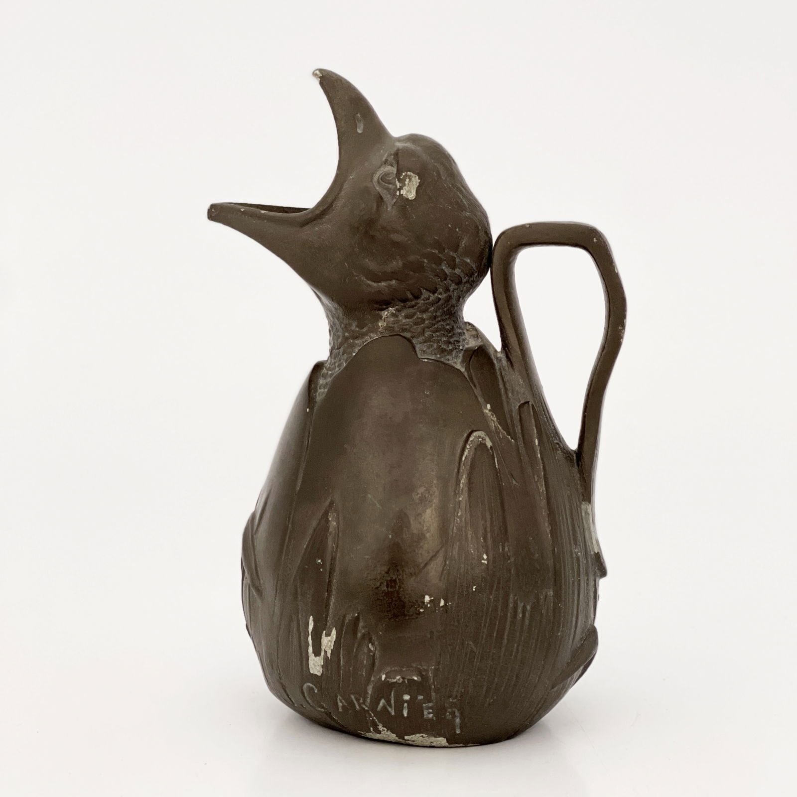 Jean Garnier, a French Art Nouveau novelty pewter jug, circa 1900, modelled as a chick emerging from: Jean Garnier, a French Art Nouveau novelty pewter jug, circa 1900, modelled as a chick emerging from a cracked shell, mouth open, signed in the cast J Garnier, stamped marks Eatain Garnier, Paris, 17.