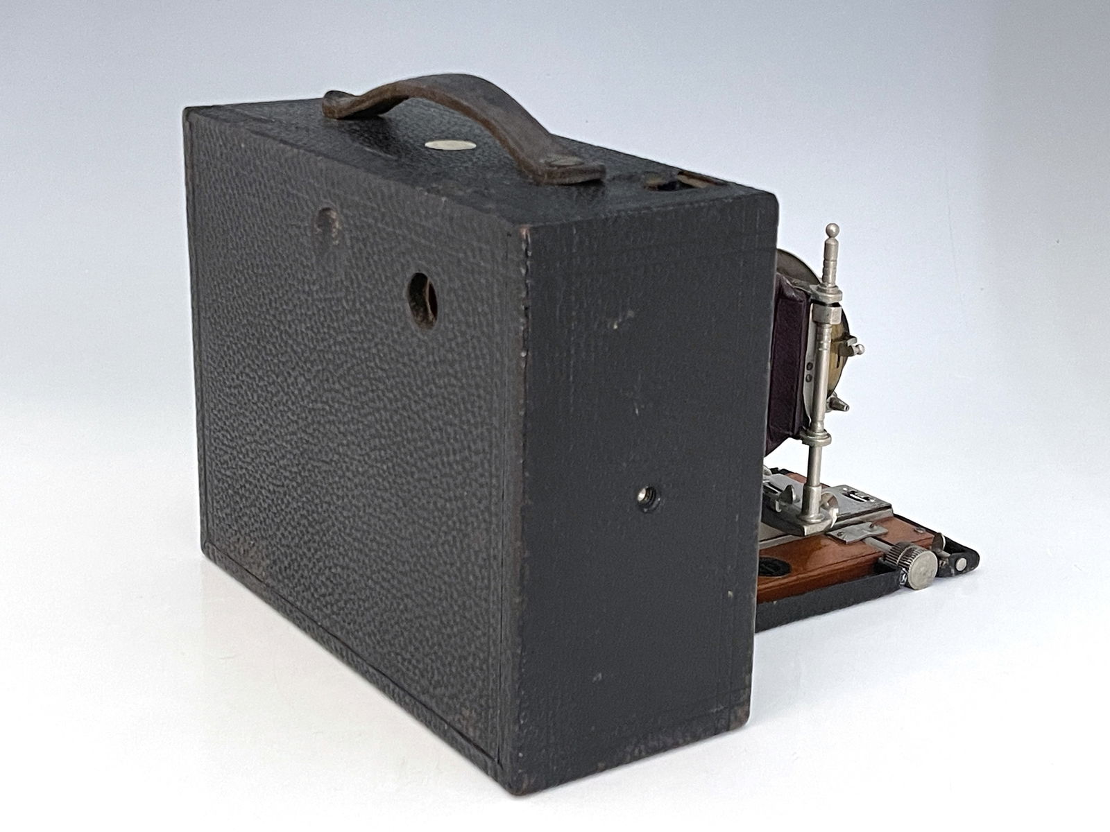 An Eastman Kodak Cartridge concertina camera, brown bellows, with ivorine Sands Hunter plaque, 16cm: An Eastman Kodak Cartridge concertina camera, brown bellows, with ivorine Sands Hunter plaque, 16cm high, 21cm wide.