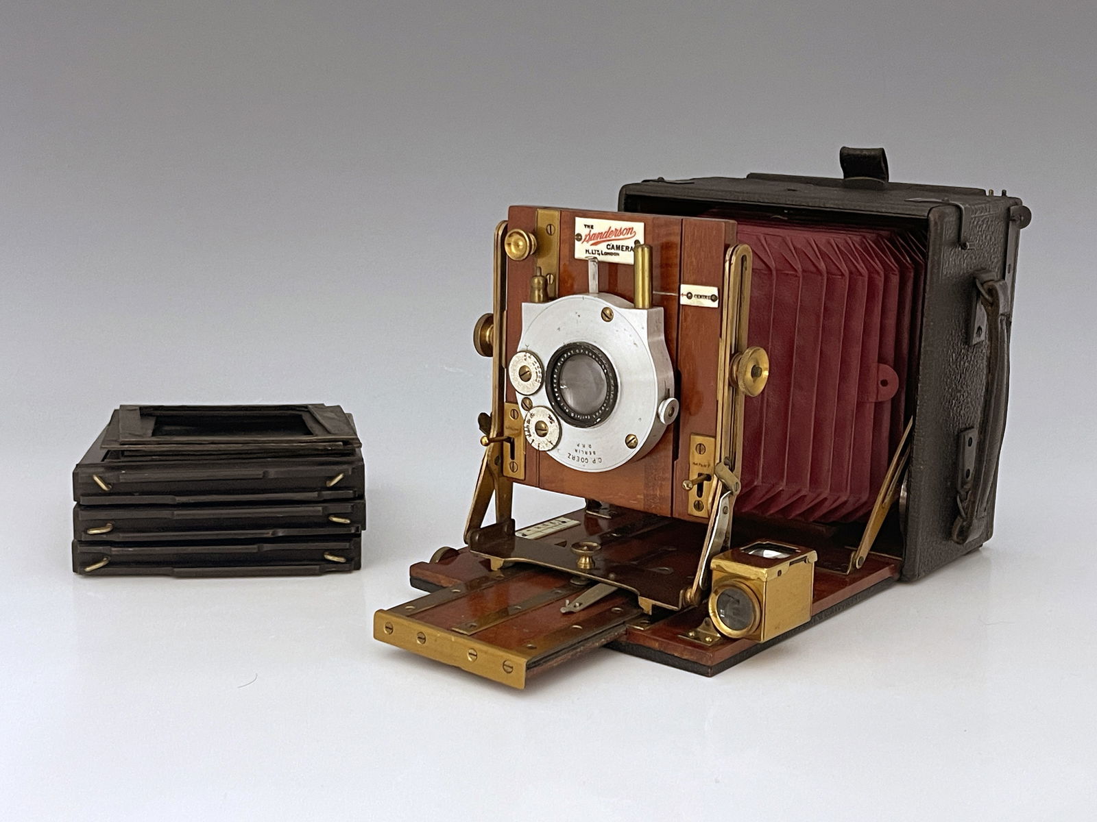 A Sanderson 4x5 Field concertina camera, red bellows, brass, and mahogany fittings with a C.P. Goerz (1 of 1)