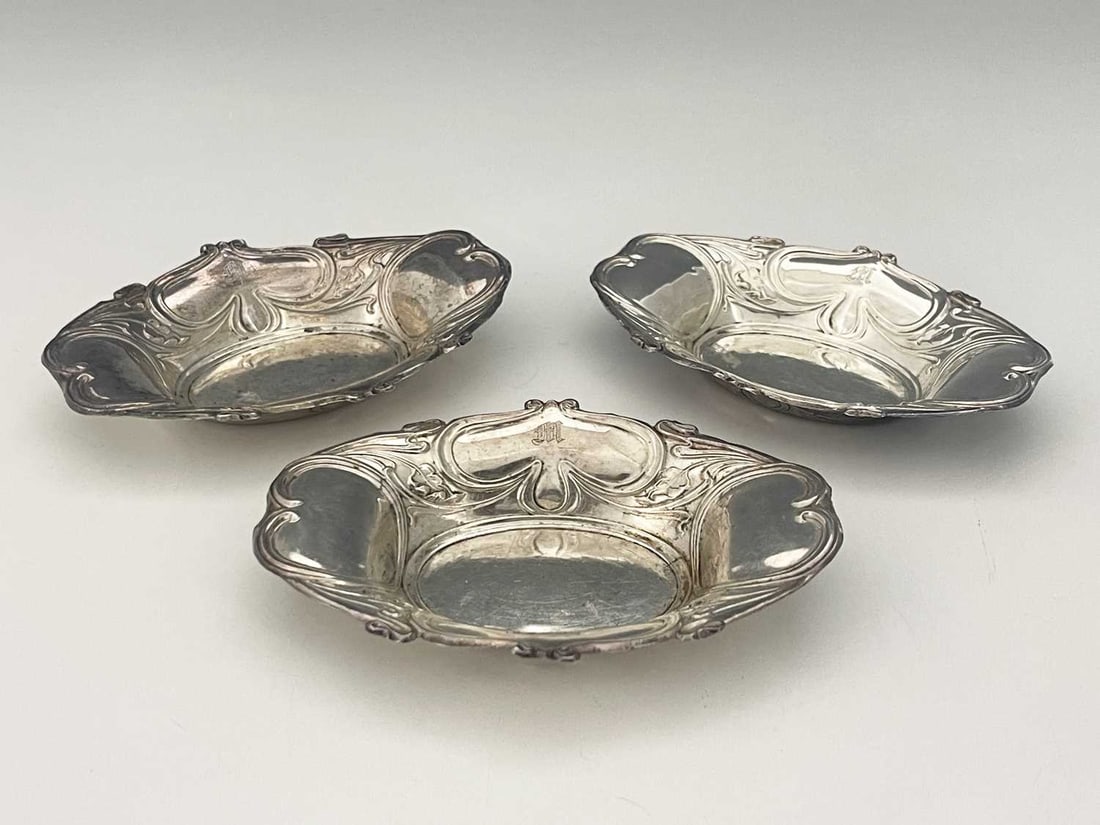 A set of three George V silver Art Nouveau bon bon dishes, each of shaped oval form, decorated with (1 of 4)