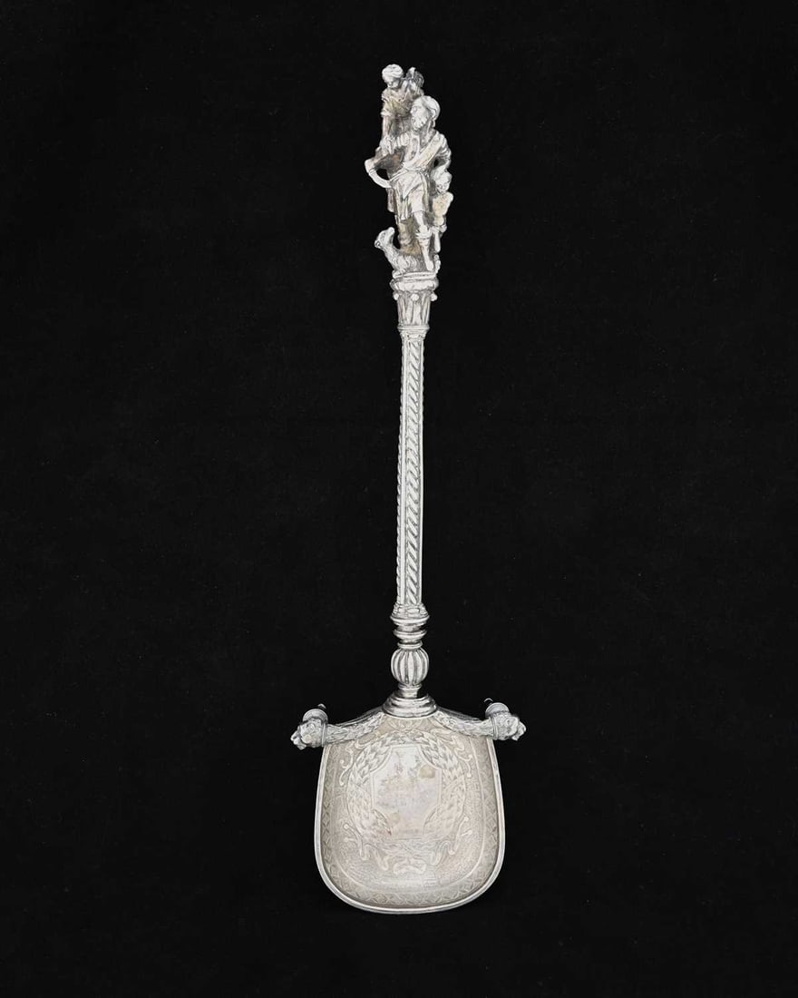 A nineteenth-century Continental silver-coloured metal serving or presentation spoon, with cast (1 of 3)