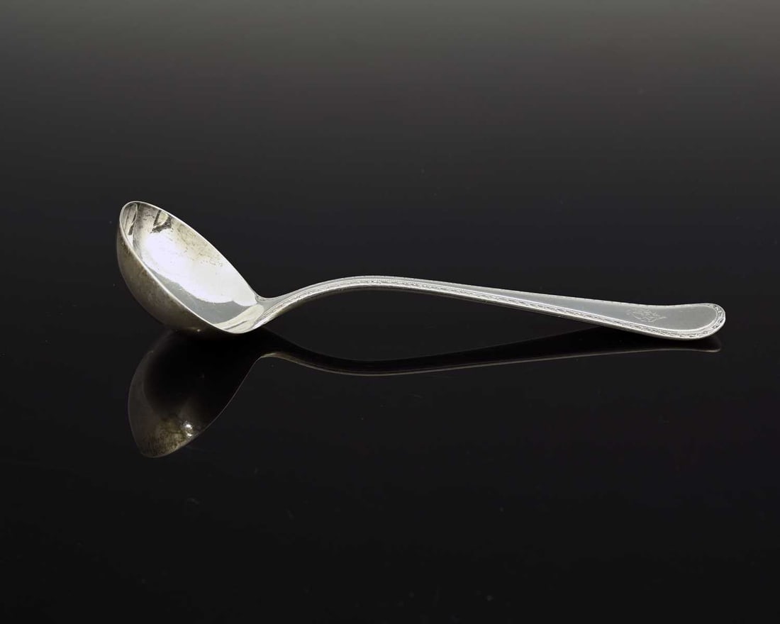 A Victorian silver sauce ladle, Old English pattern with decorated edge, the terminal with a cypher,: A Victorian silver sauce ladle, Old English pattern with decorated edge, the terminal with a cypher, Frederick Elkington, Birmingham 1878, length 18.5cm, weight 83g/2.66ozt approx