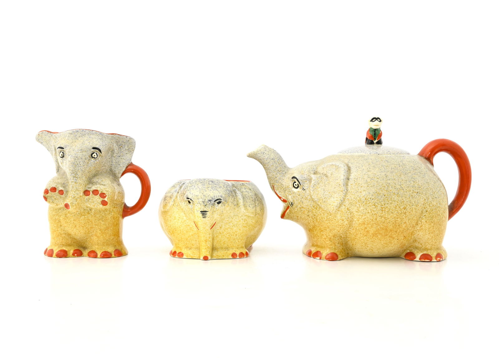 A John Steventon, Royal Venton Ware nove: A John Steventon, Royal Venton Ware novelty three piece circus elephant tea set, comprising elephant teapot and lid with figural finial, milk jug and sugar bowl, makers marks to underside, 20cm long (