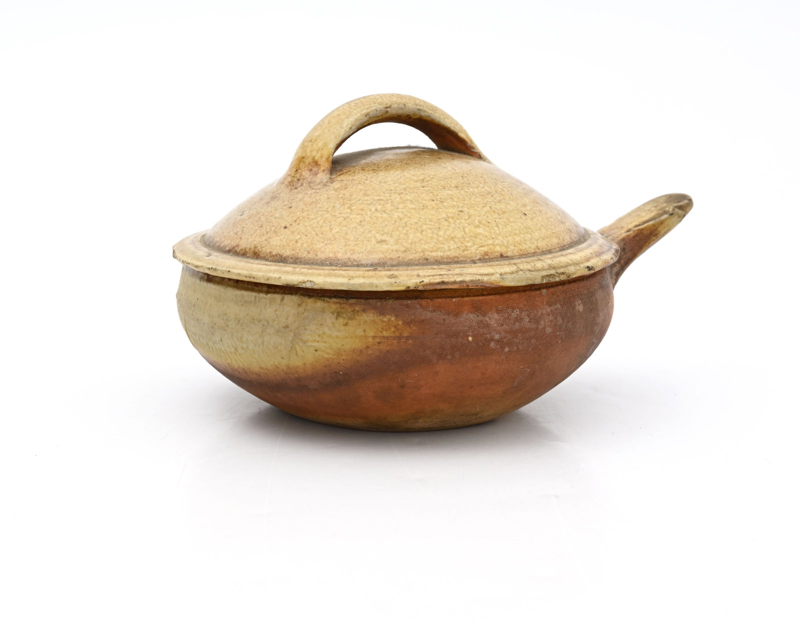 Michael Cardew for Wenford Bridge, a stu: Michael Cardew for Wenford Bridge, a studio pottery handled dish and cover, circa 1950, squat rounded form, impressed pottery and personal seal marks, 18cm long