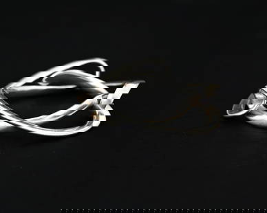 Regitze Overgaard for Georg Jensen, a Da: Regitze Overgaard for Georg Jensen, a Danish Modernist silver Infinity bracelet, model 452, designed 2004, three interlocked twisted ribbon links, 9cm diameter, 83g