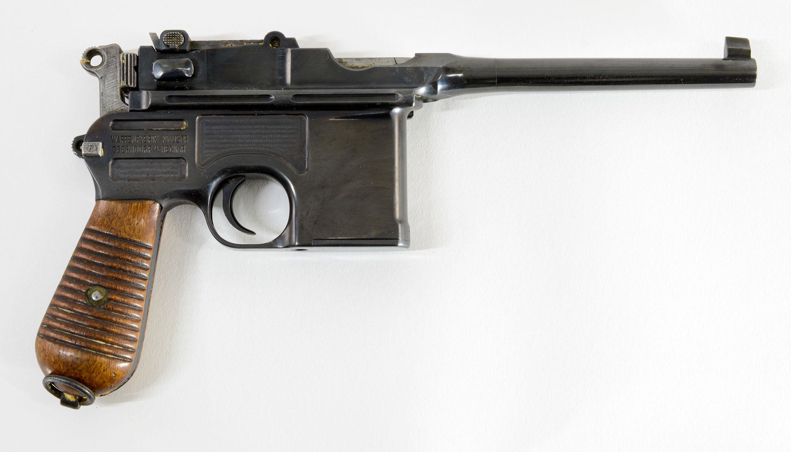 Commercial Mauser C96 9mm Pistol: Excellent and high condition Mauser C96 Broomhandle Commercial Pistol. 5.5" smooth tapered barrel, wood grips, and blued finish. Serial 841087 on barrel, matches frame and action serial numbers (087).
