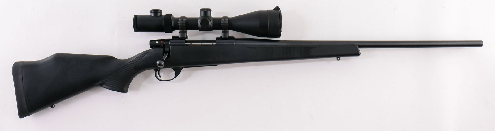 Weatherby Vanguard .223 Rifle: Weatherby Vanguard Bolt Action Rifle in .223 Remington. 24" round bbl, black synthetic stock. Mounted with a Weaver Classic Extreme 2.5-10X56 SF Scope with clear optics. VG-EX overall with some marks 