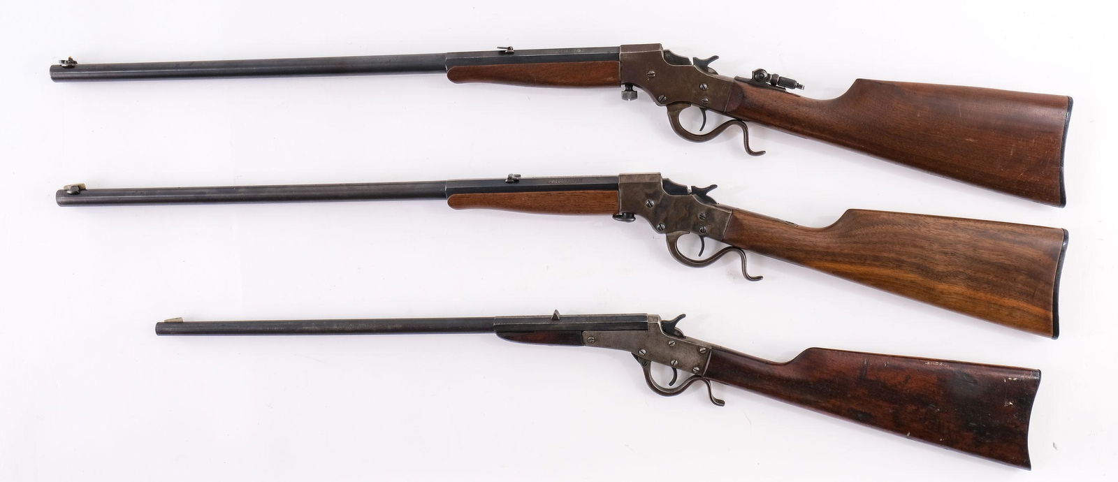 3 Stevens Single Shot Rifles: Three Stevens Single Shot Boys rifles: .22 LR Maynard Junior with 18" barrel, grainy bore, weak rifling, marks to stock, worn finish, breech damaged, NSN. A Stevens Favorite Takedown 20.5" bbl, Single