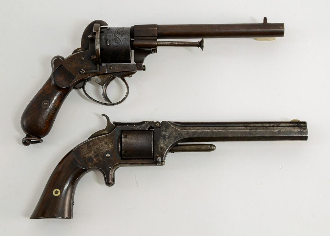 Two Antique Revolvers: A Smith & Wesson No. 2 in .32 rimfire with a 6" barrel. Dark Grey Patina and traces of original finish. OK Function. Pitted Bore. Serial Number 15420 together with a Lefaucheux Belgian Pinfire Revolve