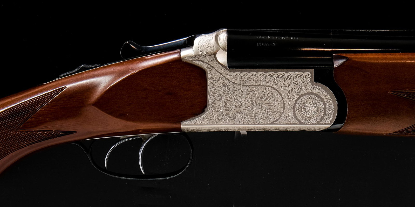 Charles Daly O/U Shotgun 105 12ga 3": Charles Daly model 105 in 12 gauge 3" double trigger with a two shell capacity and a 28" barrel. The rubber butt pad is in fair condition with moderate wear. The butt stock is in very good condition w