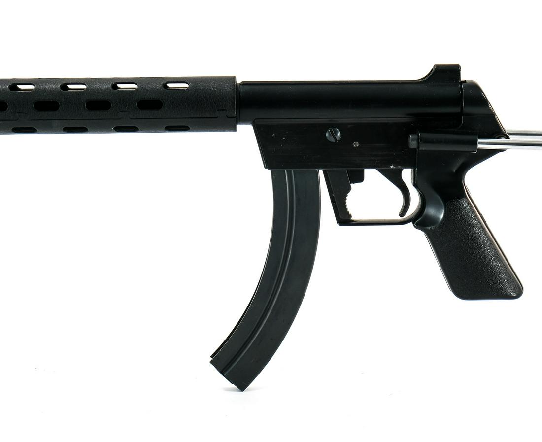 Armalite AR-7 .22 LR Wire Stock Rifle: Armalite AR-7 in .22 long rifle with a high capacity twenty five round removable magazine and a 16" barrel. The stock has been replaced with a pistol grip and arm brace extension from "Mitchell Arms" 