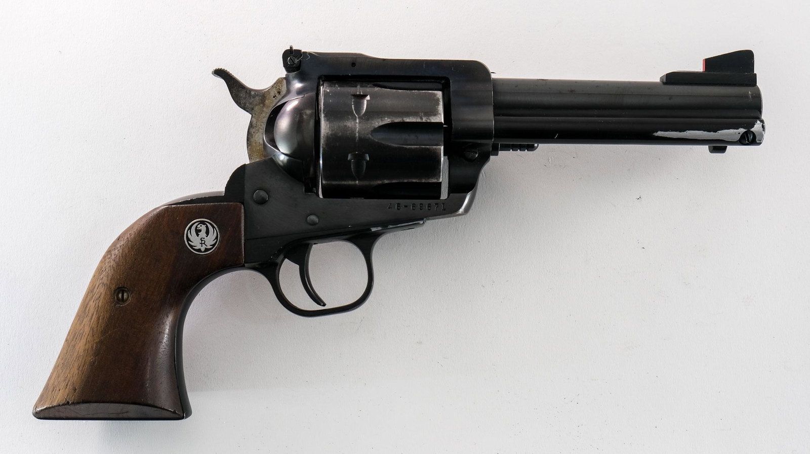 Ruger Blackhawk .45 Colt Revolver: Ruger New Model Blackhawk in SA .45 Colt with a six round capacity and a 4 1/2" barrel. The Ruger wood grip plates are in good condition with light handling wear no damage. The frame is in fair condit