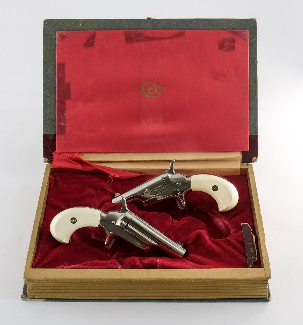 Colt Derringer Set 4th Model .22 Short Circa 1960s: Colt Derringer set 4th model in .22 short with a single shot capacity and a 2 1/2" barrel. This is a two gun sequential serial number set with white faux ivory hand grips. The grips on both pistols ar