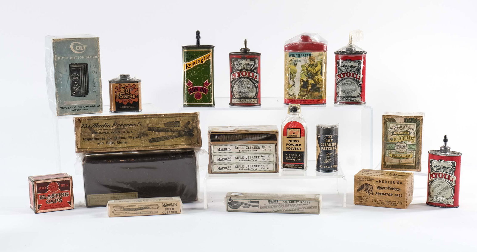 Firearms and Sporting Advertising Group: All Period, original pieces including tins, boxes and bottles from: Nyoil Gun Oil Lubricant, Remington Gun Oil, Gun Cleaning Patches, Nitro Powder Solvent, Herters Famous Predator Call (call present),