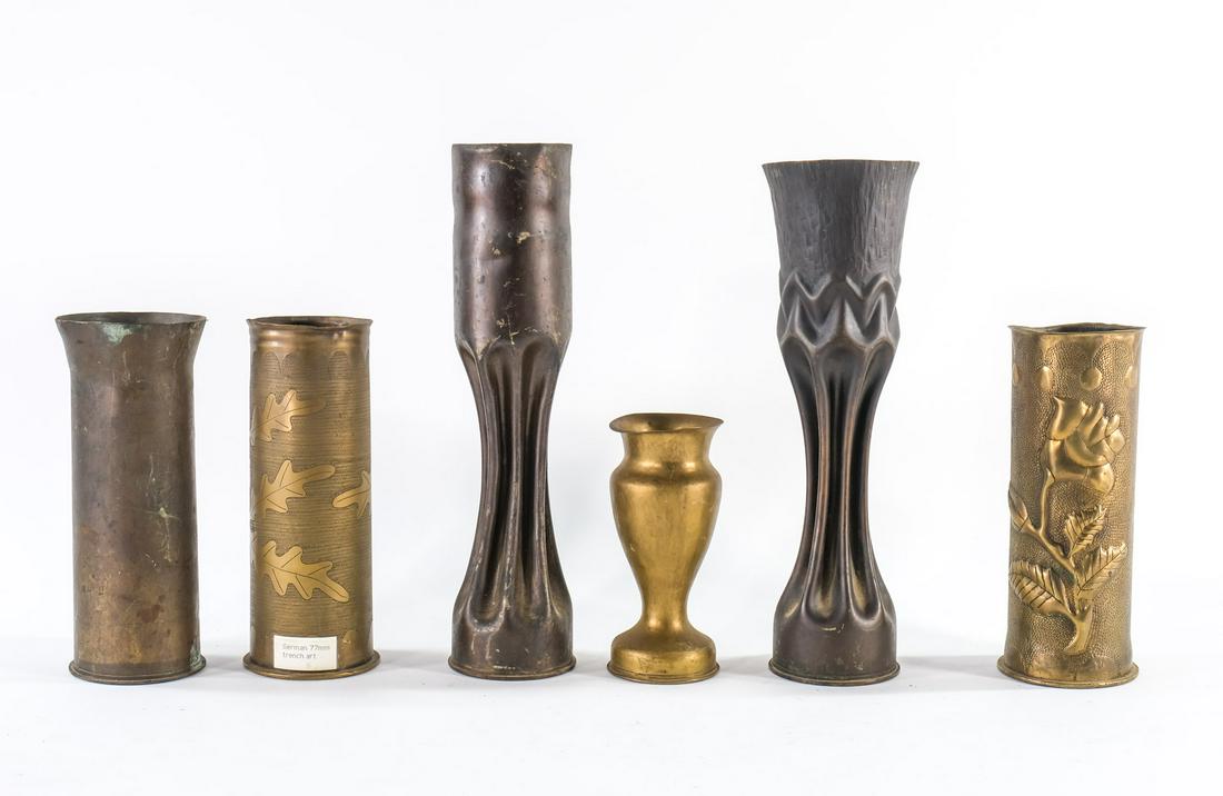 Six WWI Trench Art Artillery Shells: German 77mm with Oak Leaf design, 1917 3 in shell, two crimped, 1916, floral design, etc. Good condition, original patina. largest 13.5"Keywords: POW, World War One, Germany, France, Antique, Folk Art