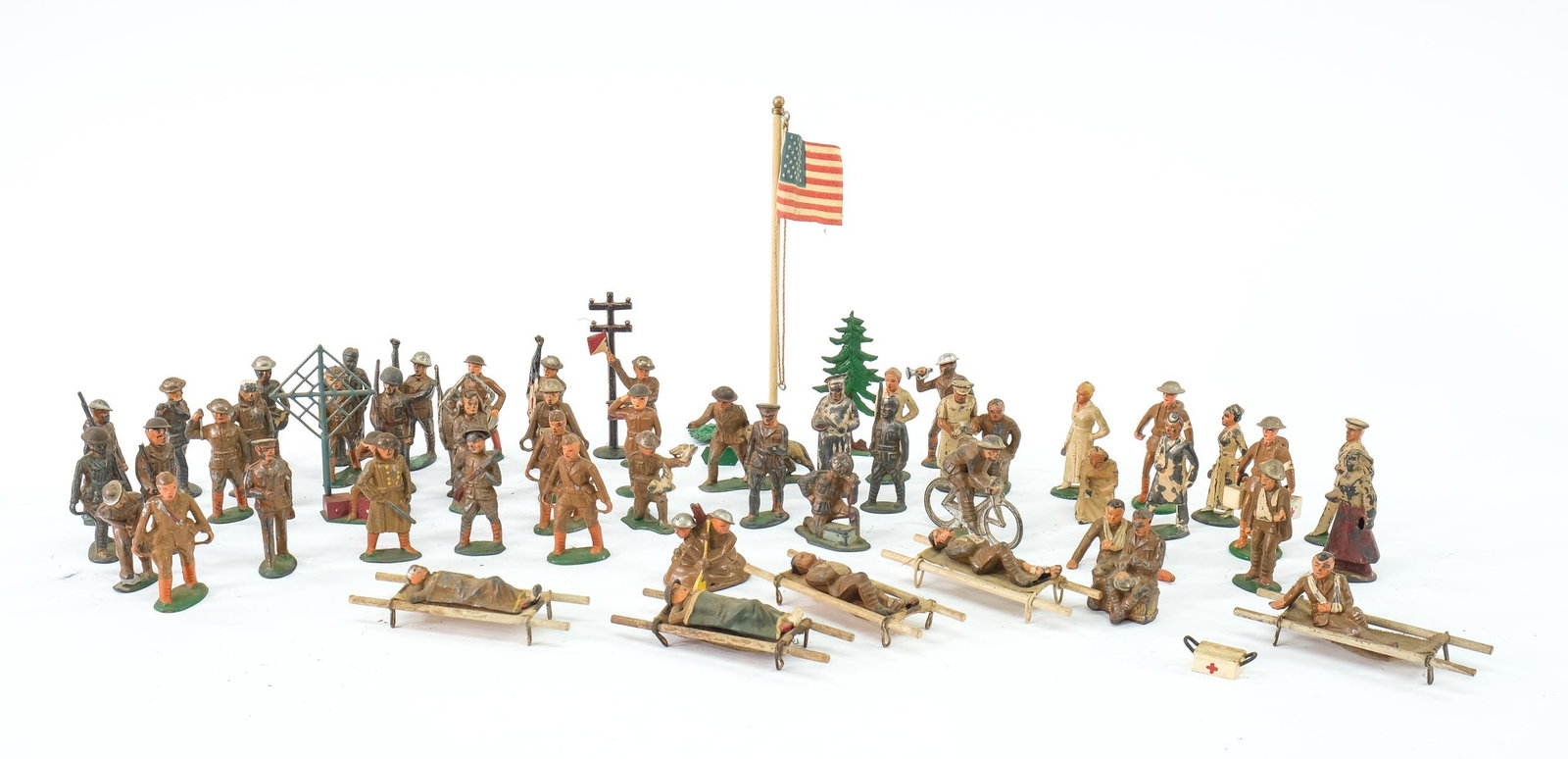 Dimestore Cast Metal Toy Soldiers: Over 50 pcs. Lead and cast metal WWI Doughboy and related toy soldiers marked and unmarked including Manoil, Barclay, Holt, etc. Includes Nurses, medics, scenery pieces, and more. Condition varies wit