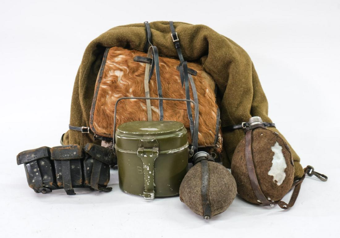 German Military Kit: Original German WWI (?) "mountain" kit. Lot includes one back pack rig which includes metal mess kit, one wool bed roll, 2 canteens, and one leather ammo belt rig. Pack appears to be constructed of re