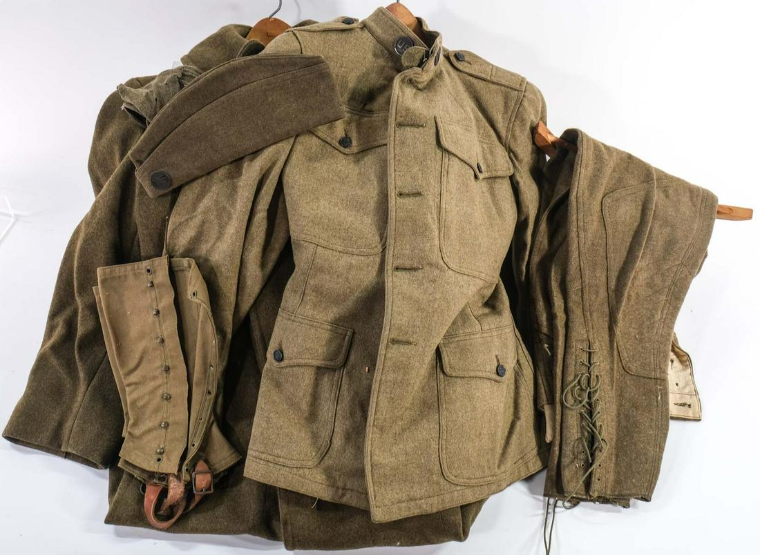 Mixed Military Uniform and Accessory Group: Estate-Fresh, Wool coat, tunic, Leather Map Case, Holsters, Miller Mfg. Breeches, Cap, Spats or Gaiters, Belt setup with Entrenching tool, Pickaxe, First Aid Kit, Ammo Pouches, grenade belt with four