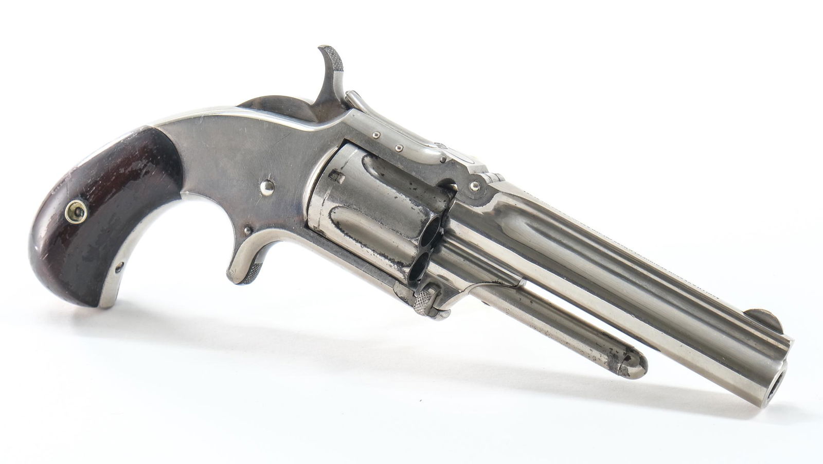 S&W Model 1-1/2 Tip-Up .32RF Revolver: Smith & Wesson No. 1 No. 1 1/2 New Model Tip-Up chambered in .32 RF. This example has a 3-1/2", round barrel, fluted cylinder and rosewood grips on a birds head grip frame. The serial number of this e