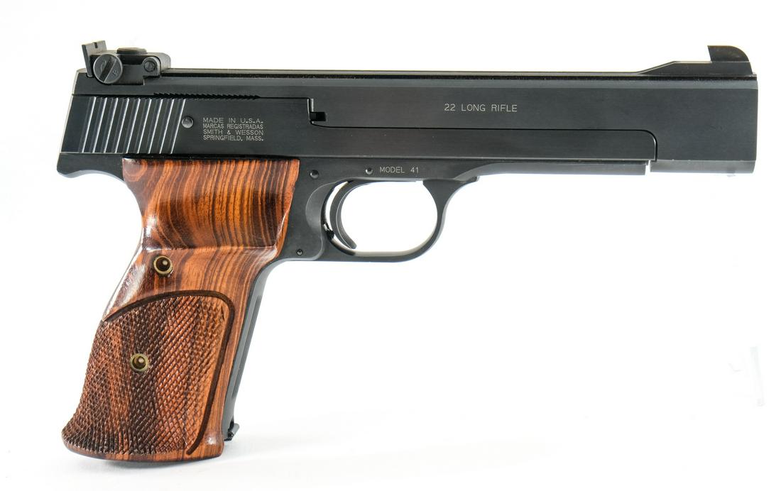 Smith & Wesson 41 .22 LR Target Pistol: S&W model 41 in .22 long rifle with one, twelve round removable magazine and a 5.5" barrel. Sharp clean checkered wood grip plates with a thumb rest on each side. Frame and slide with light surface sc