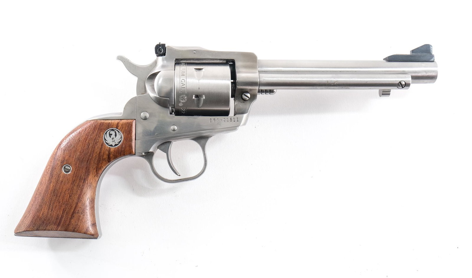 Ruger NM Single Six .22 Mag Revolver: Ruger New Model single six in .22 magnum with a six shot capacity and a 6" barrel. Ruger wood grip plates with light handling wear no cracks or chips. Polished steel frame with light metal oxidation o