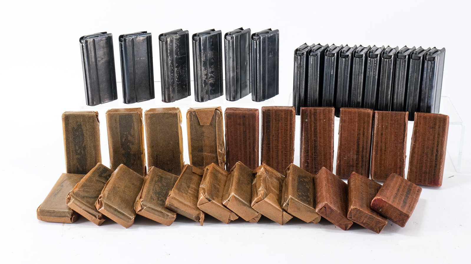 M1 .30 Carbine Magazines 38 pieces: This lot is for thirty eight, fifteen round M1 Carbine .30 Carbine magazines. Twenty two of them are new and still wrapped in wax paper. Sixteen are open and have been used, some with metal oxidation 