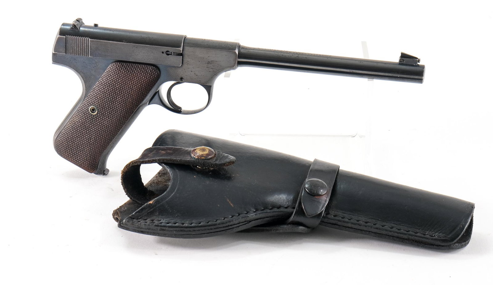 Colt Woodsman .22 LR Pistol: Colt Woodsman in .22 long rifle with one, ten round removable magazine and a 6.5" barrel. Checkered wood grip plates with heavy wear, no cracks or chips. Frame with touches of metal oxidation and shar