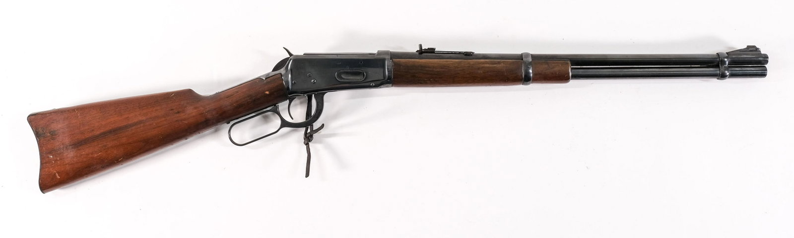 Winchester 94 1899 Lever action Rifle .32 WS: Winchester Model 94 in .32 W.S. with a 20" barrel. Circa 1899. The hardwood stock is in fair condition with moderate surface wear. No deep chips or cracks throughout. The front grip has moderate wear 